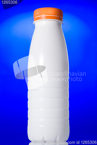 Image of White milk bottle isolated on blue