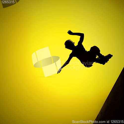 Image of silhouette of roller boy jumping in air