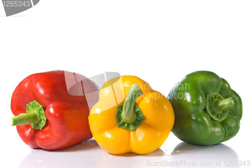 Image of red, yellow and green pepper with water drops isolated on white