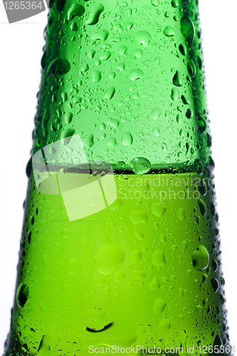 Image of Green beer bottle with water drops isolated on white