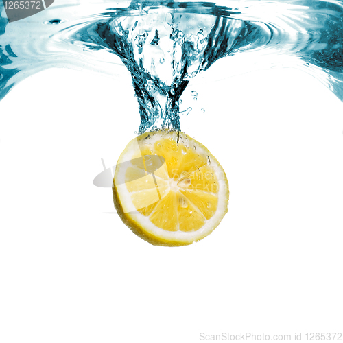 Image of Fresh lemon dropped into water with bubbles isolated on white