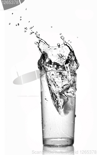 Image of water splash in glass isolated on white