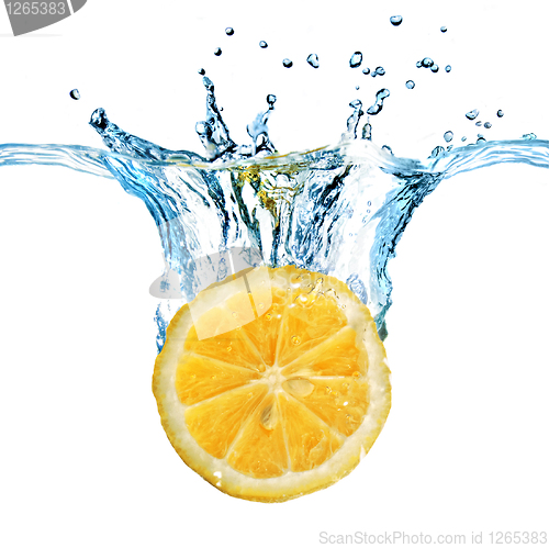 Image of Fresh lemon dropped into water with splash isolated on white