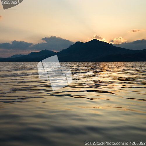 Image of landscape with sea and mountains on sunset