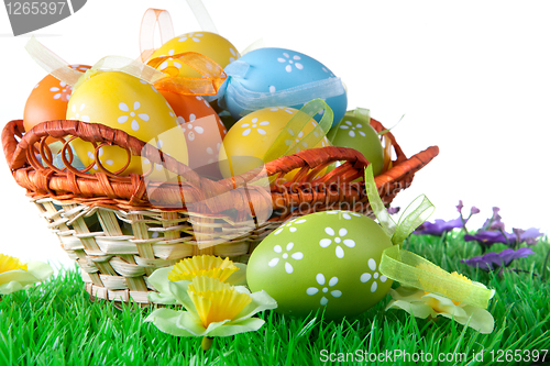 Image of color easter eggs in basket isolated on white