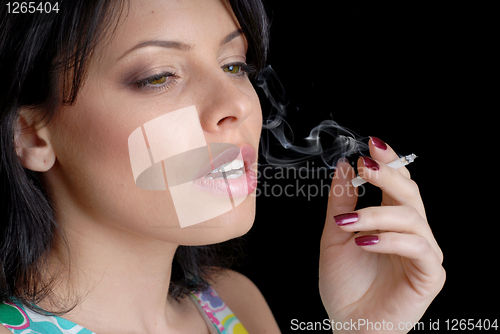Image of woman smoking on black background