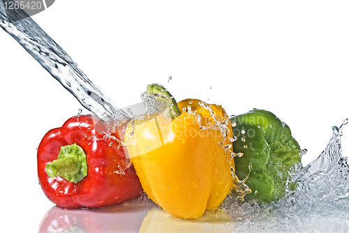 Image of red, yellow and green pepper with water splash isolated on white