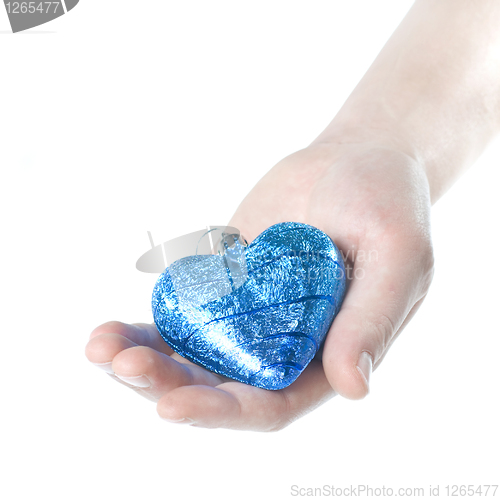 Image of arm holding blue christmas ball in shape of heart isolated on wh