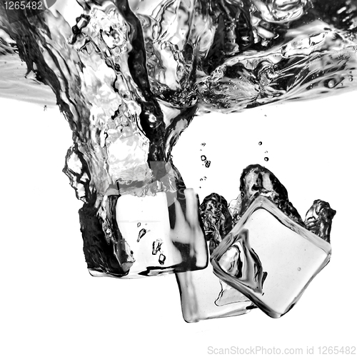 Image of ice cubes dropped into water with splash isolated on white