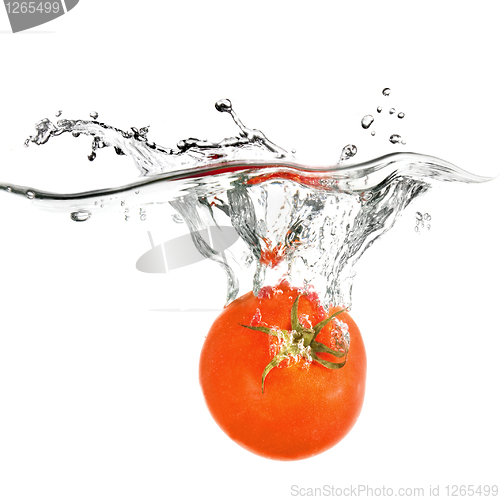 Image of red tomato dropped into water isolated on white