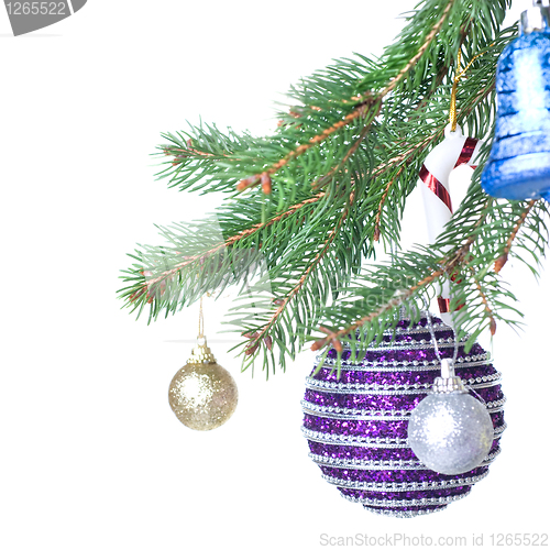 Image of Christmas balls and decoration on fir tree branch isolated on wh