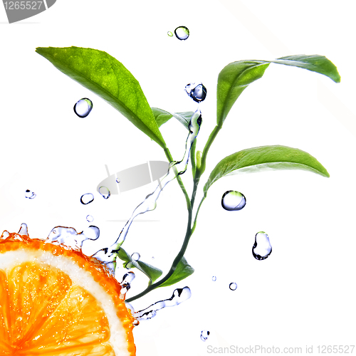 Image of water drops on orange with green leaves isolated on white