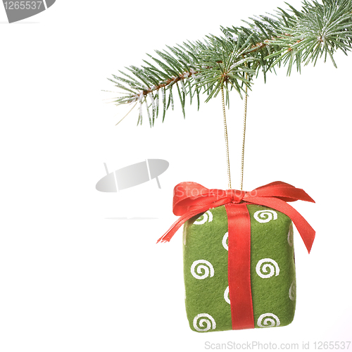 Image of Christmas gift on fir tree branch with snow isolated on white