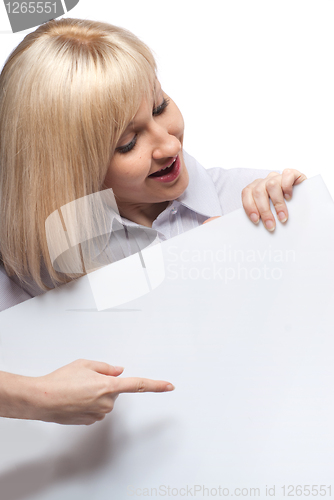 Image of Attractive smiling woman holding white empty paper isolated on white