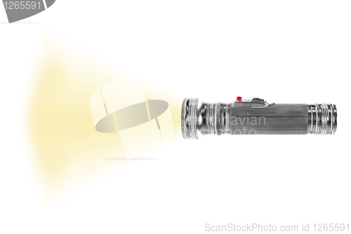 Image of turned on metal flashlight isolated on white