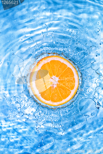 Image of Fresh orange dropped into water with bubbles isolated on white