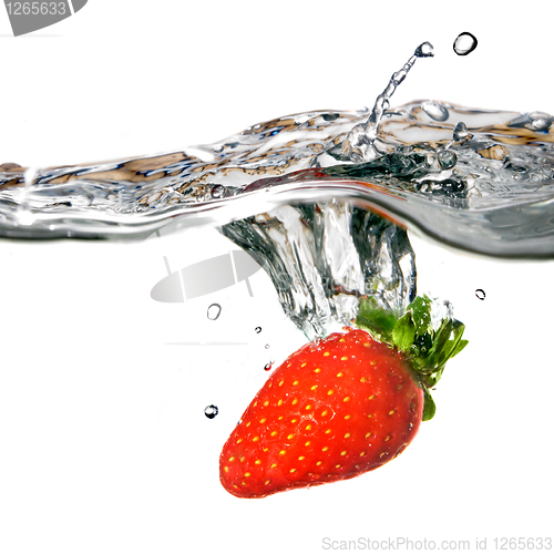 Image of Fresh strawberry dropped into water with splash isolated on whit