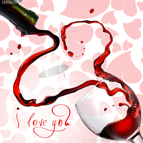 Image of Heart from pouring red wine in goblet isolated on white