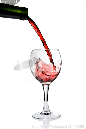 Image of Pouring red wine in goblet isolated on white