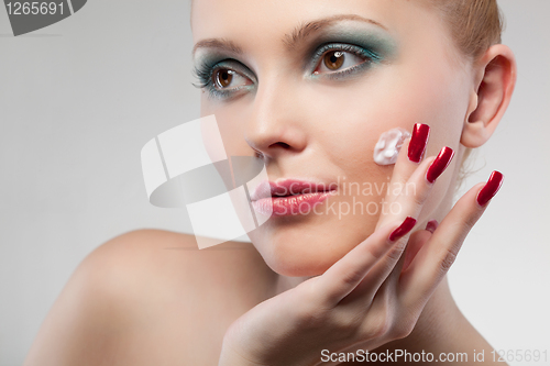 Image of portrait of woman with cream  isolated on white