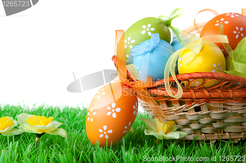 Image of color easter eggs in basket isolated on white