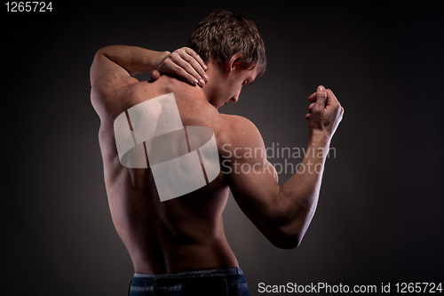 Image of Muscular naked man from back on black