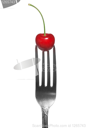 Image of red cherry on fork isolated on white