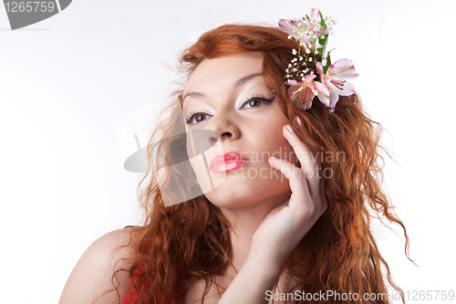 Image of Portrait of beautiful woman with spring flowers on white