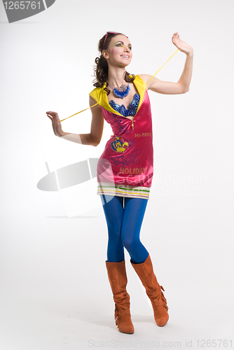Image of Beautiful young woman posing in color wear