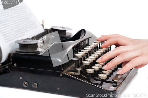 Image of Woman hands typing on vintage typewriter isolated on white