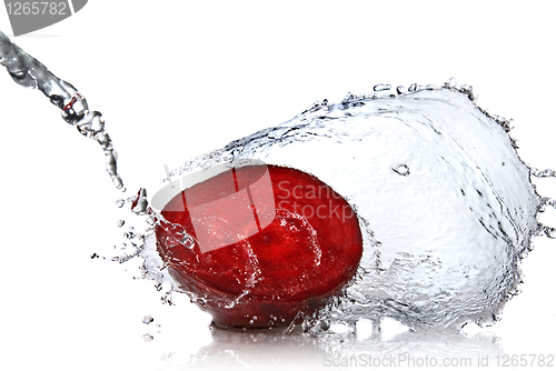 Image of red beet with water splash isolated on white