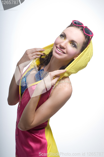 Image of Beautiful young woman in color wear on white