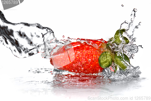 Image of Fresh strawberry and water splash isolated on white