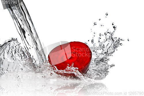 Image of red beet with water splash isolated on white