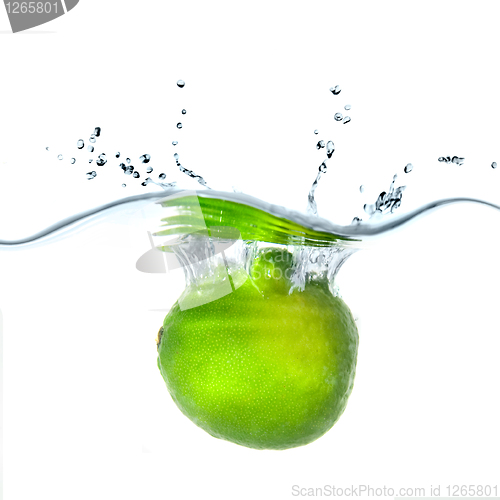 Image of Fresh lime dropped into water with bubbles isolated on white