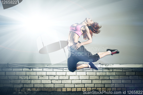 Image of girl jumping on the roof