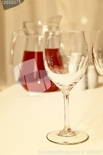 Image of glass goblet and red beverage on the table