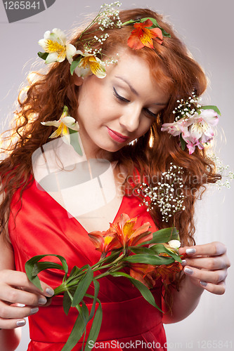 Image of Portrait of beautiful woman with spring flowers