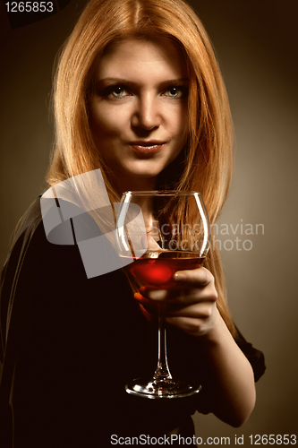 Image of woman with red hair holding wine glass