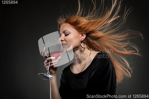Image of woman with red hair holding wine glass
