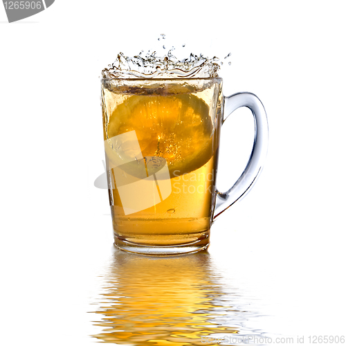 Image of lemon dropped into tea cup with splash and reflection isolated o