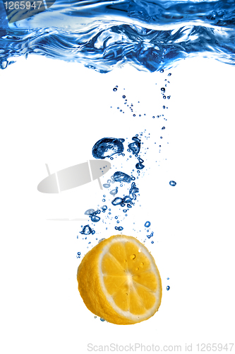 Image of Fresh lemon dropped into water with bubbles isolated on white