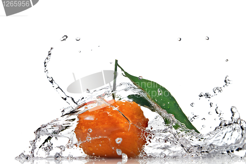 Image of Tangerine with green leaves and water splash isolated on white