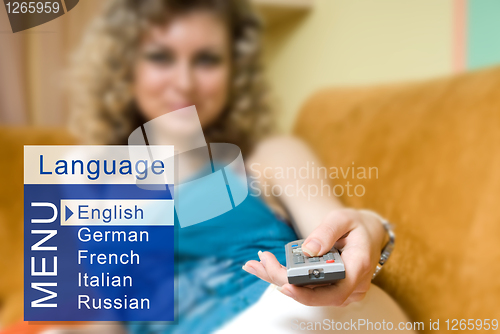 Image of A young woman chooses a language from the menu