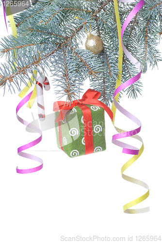 Image of Christmas gift and decoration on fir tree branch isolated on whi