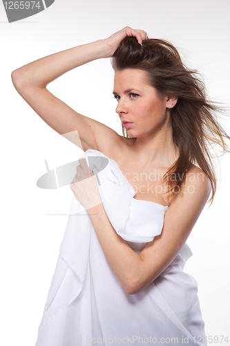 Image of Attractive woman covered in white cloth on white