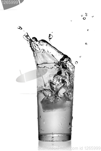 Image of water splash in glass isolated on white