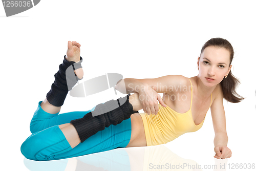 Image of attractive woman doing gymnastics on white background