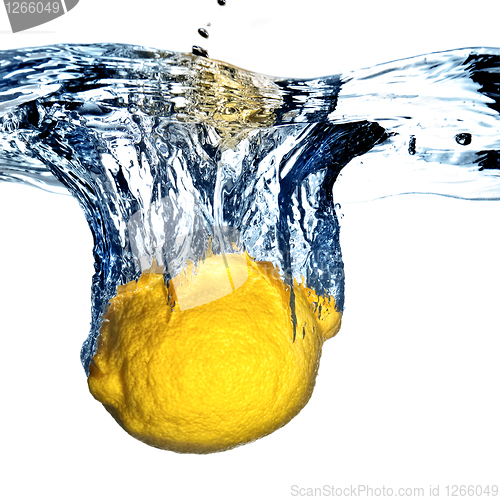 Image of Fresh lemon dropped into water with bubbles isolated on white