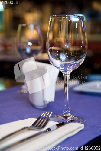 Image of wineglass on served table in restaurant